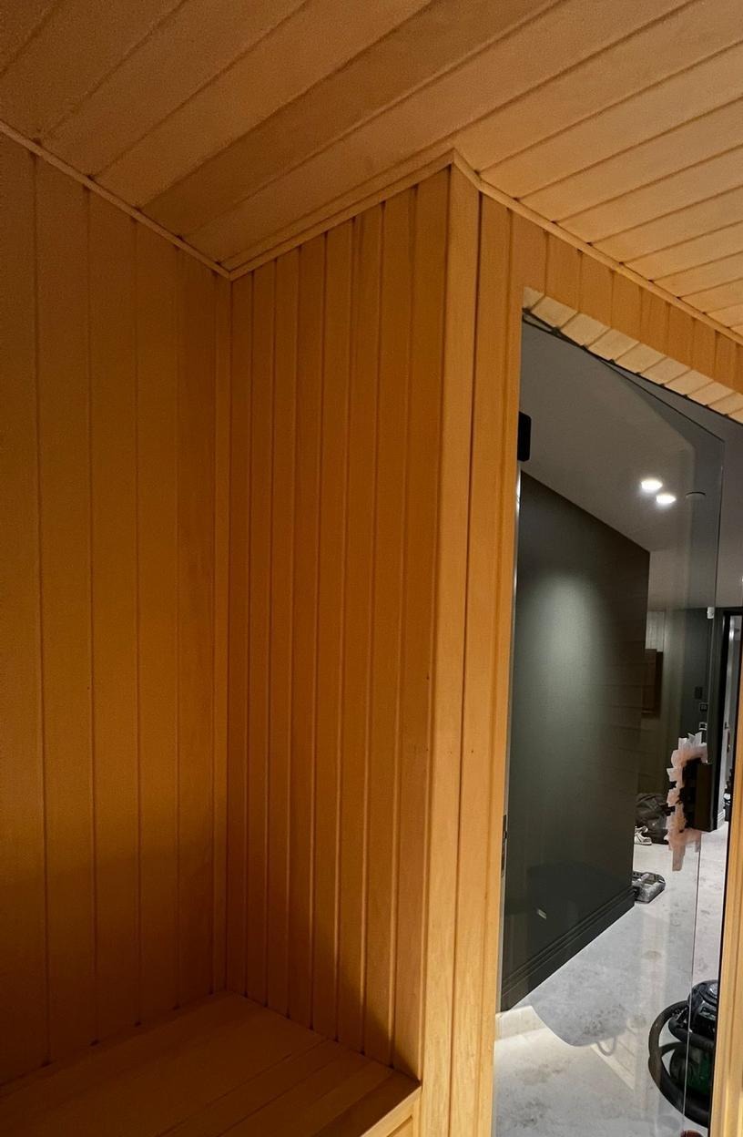 Bespoke timber sauna with seating and concealed floor lighting